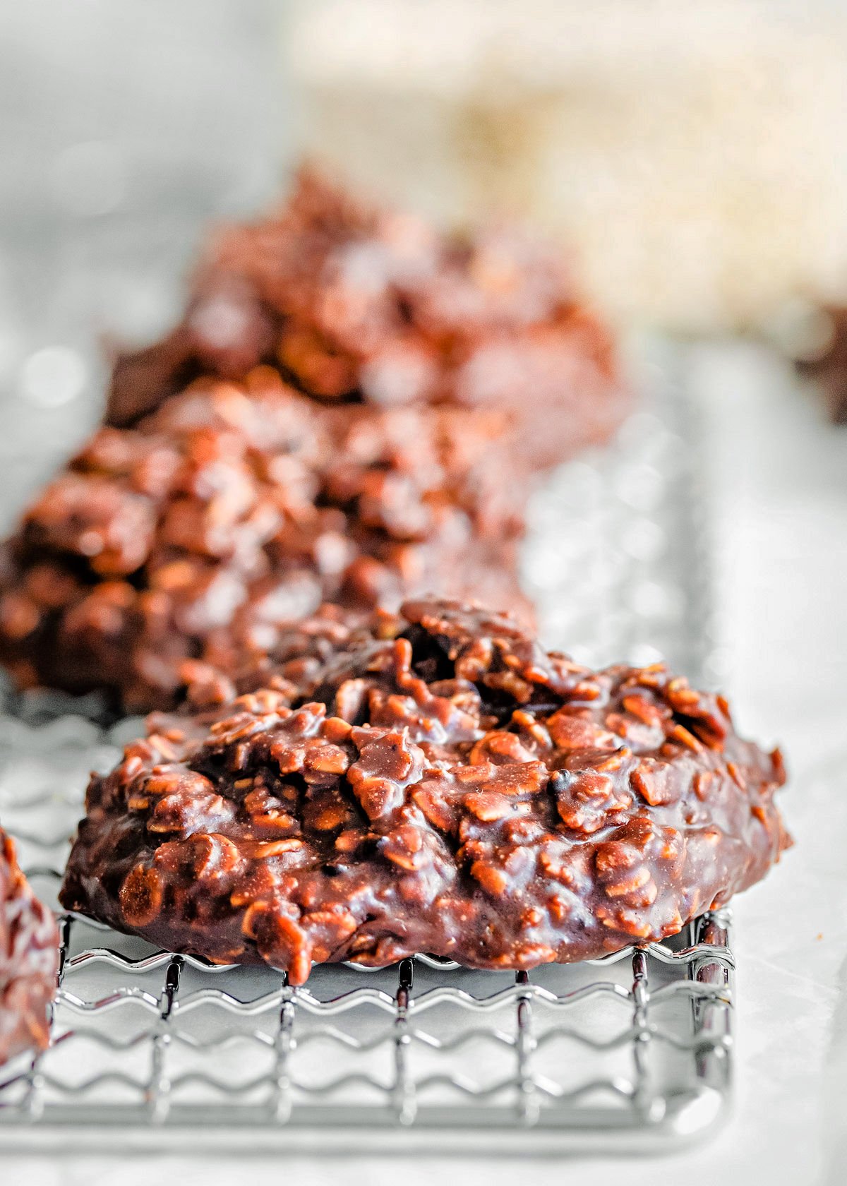 several chocolate peanut butter no bake cookies on wire cooling rack .