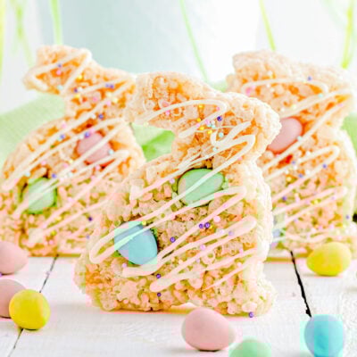 three rice krsipie treats cut into bunny shapes with cadbury chocolate eggs mixed in.