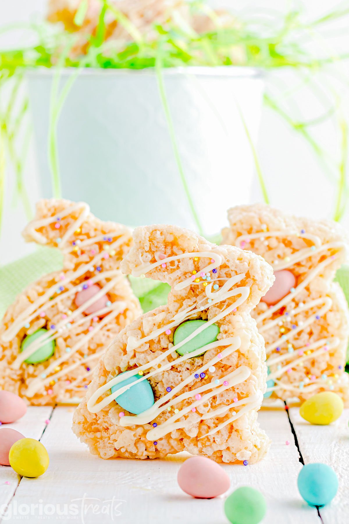 three rice krsipie treats cut into bunny shapes with cadbury chocolate eggs mixed in.