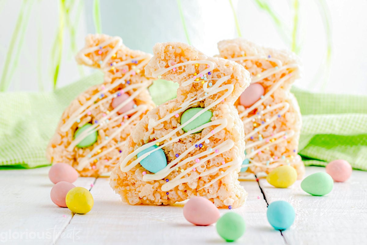 three rice krsipie treats cut into bunny shapes with cadbury chocolate eggs mixed in.