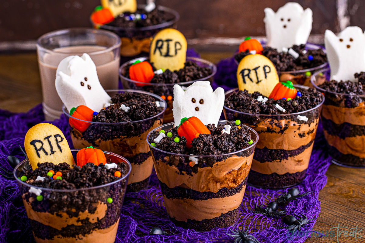 wide look at decorated dirt cups made with peeps, pumpkin candy and milano cookie tombostones.