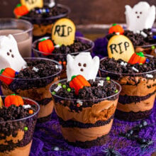 halloween decorated dirt cups made with peeps, pumpkin candy and milano cookie tombostones.