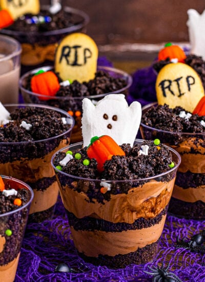 halloween decorated dirt cups made with peeps, pumpkin candy and milano cookie tombostones.