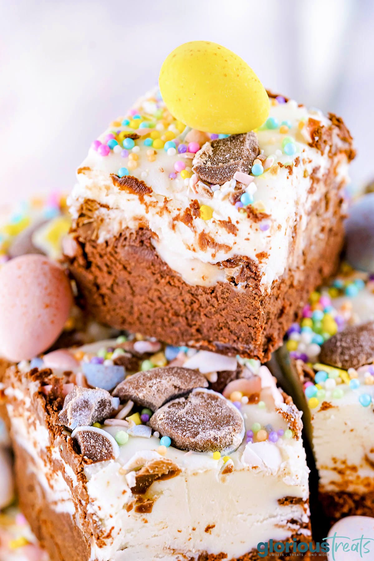close up look at easter fudge made with cadbury creme eggs stacked on a plate.