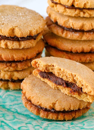 stacks of peanut butter cookies with chocolate filling. front stack's top cookie has been torn in half.