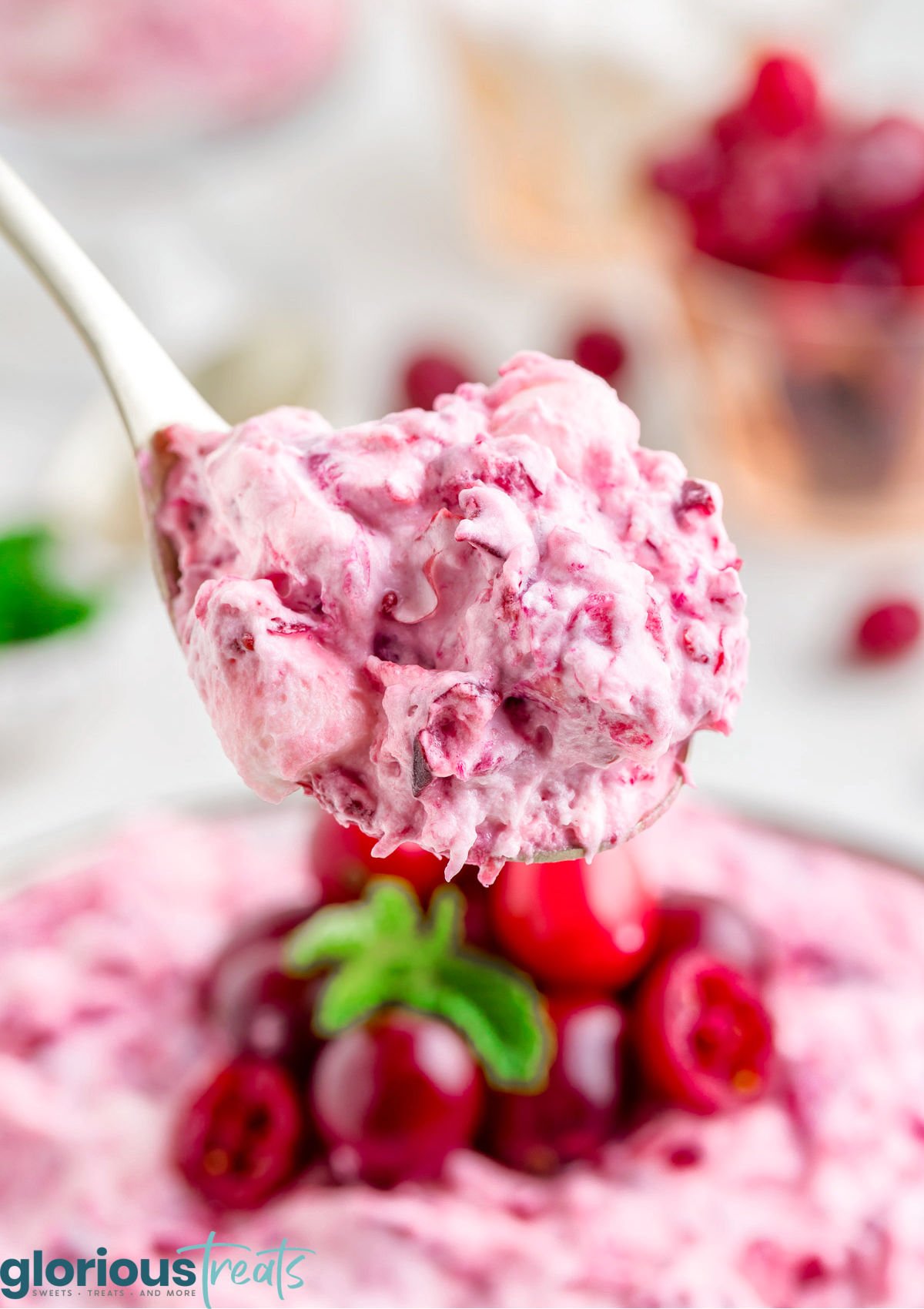 spoonful of cranberry fluff held above the serving dish.