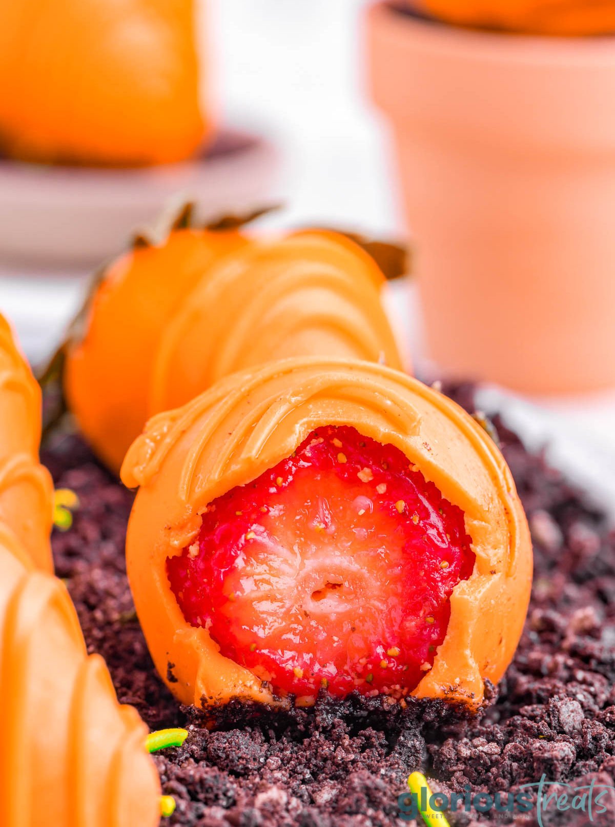 carrots strawberry bitten in half so the strawberry can be seen.