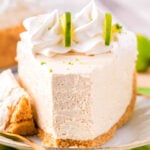 A slice of key lime cheesecake with a bite taken out of it.