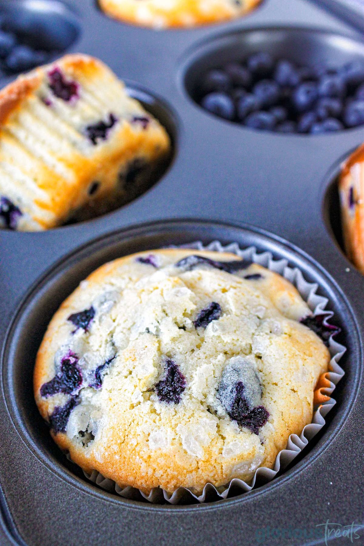 A close up shot of a muffin in a muffin tin.