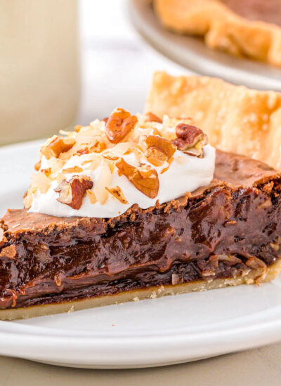A slice of german chocolate pie on a white plate.