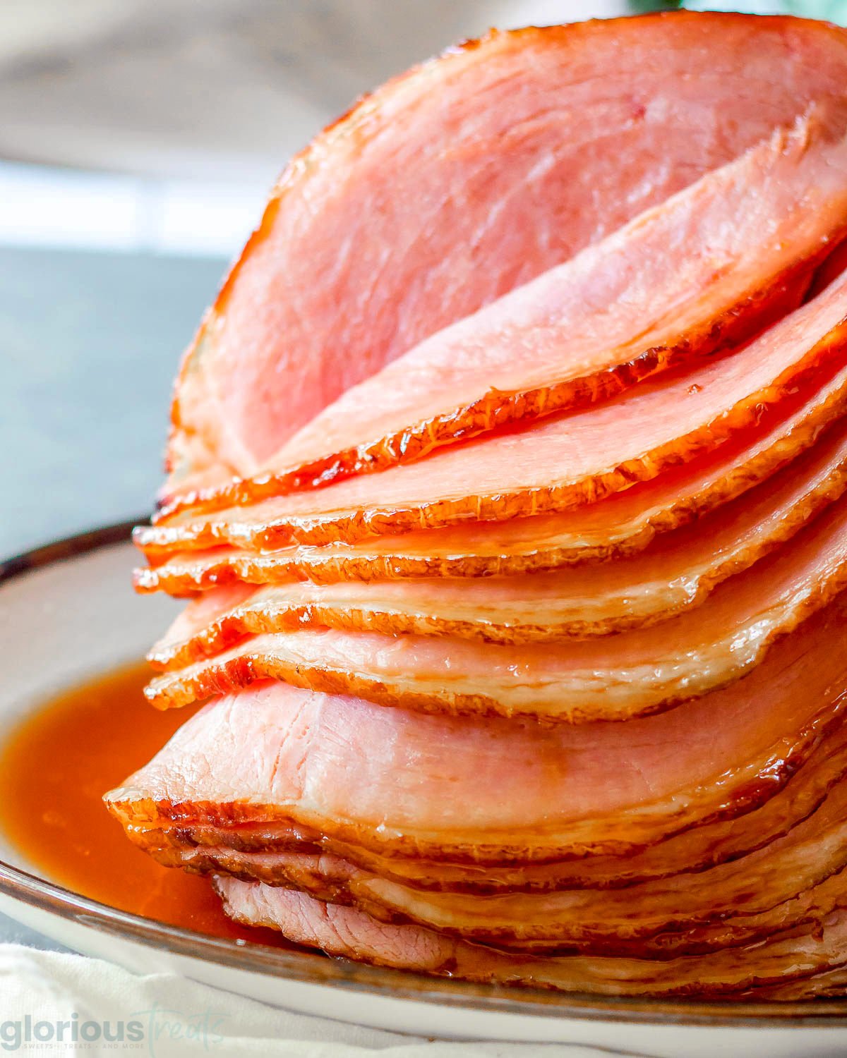 Ham glaze recipe shown on a spiral slice ham on an oval platter.