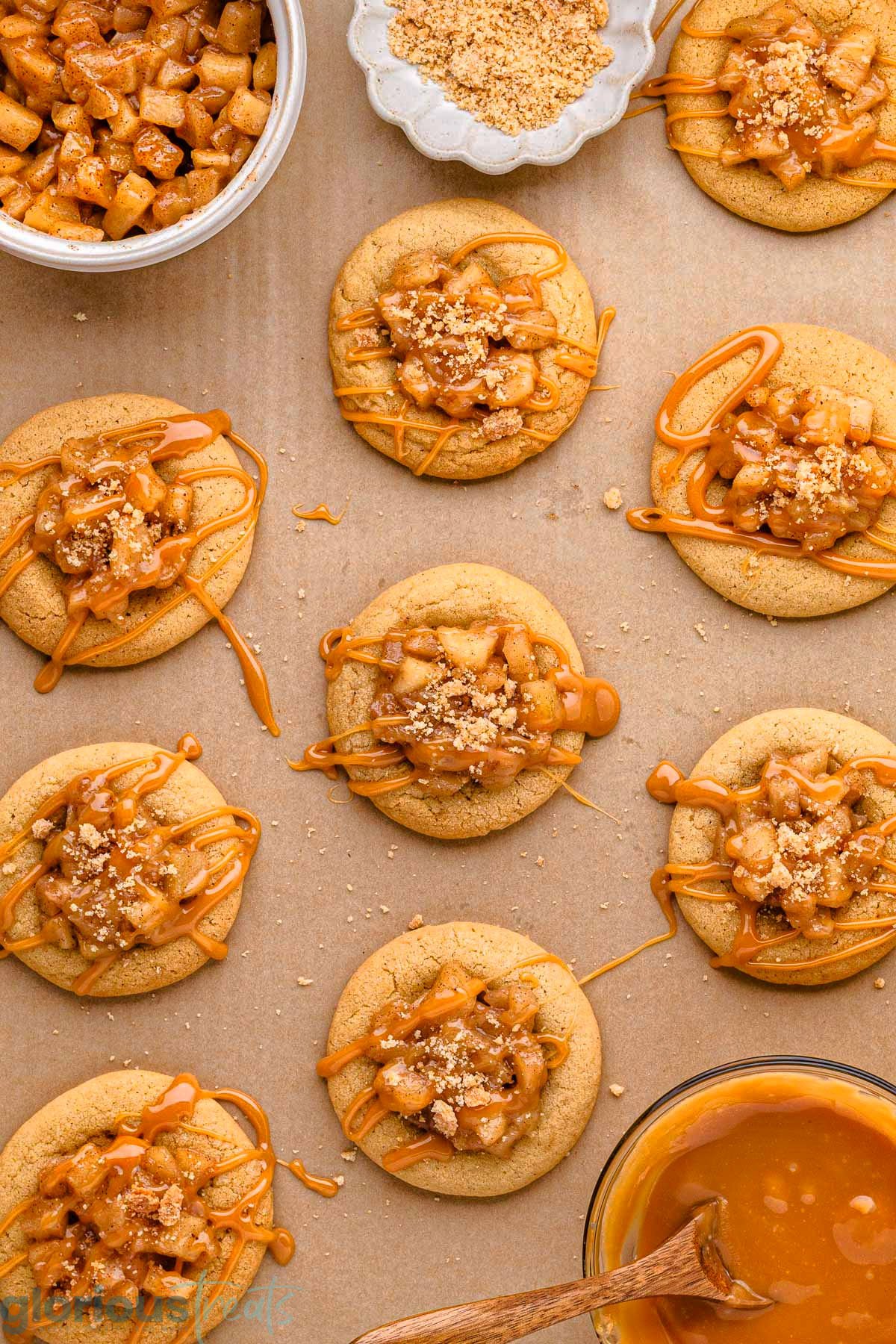 Overhead shot of caramel apple cookies on brown parchment ready to be enjoyed.