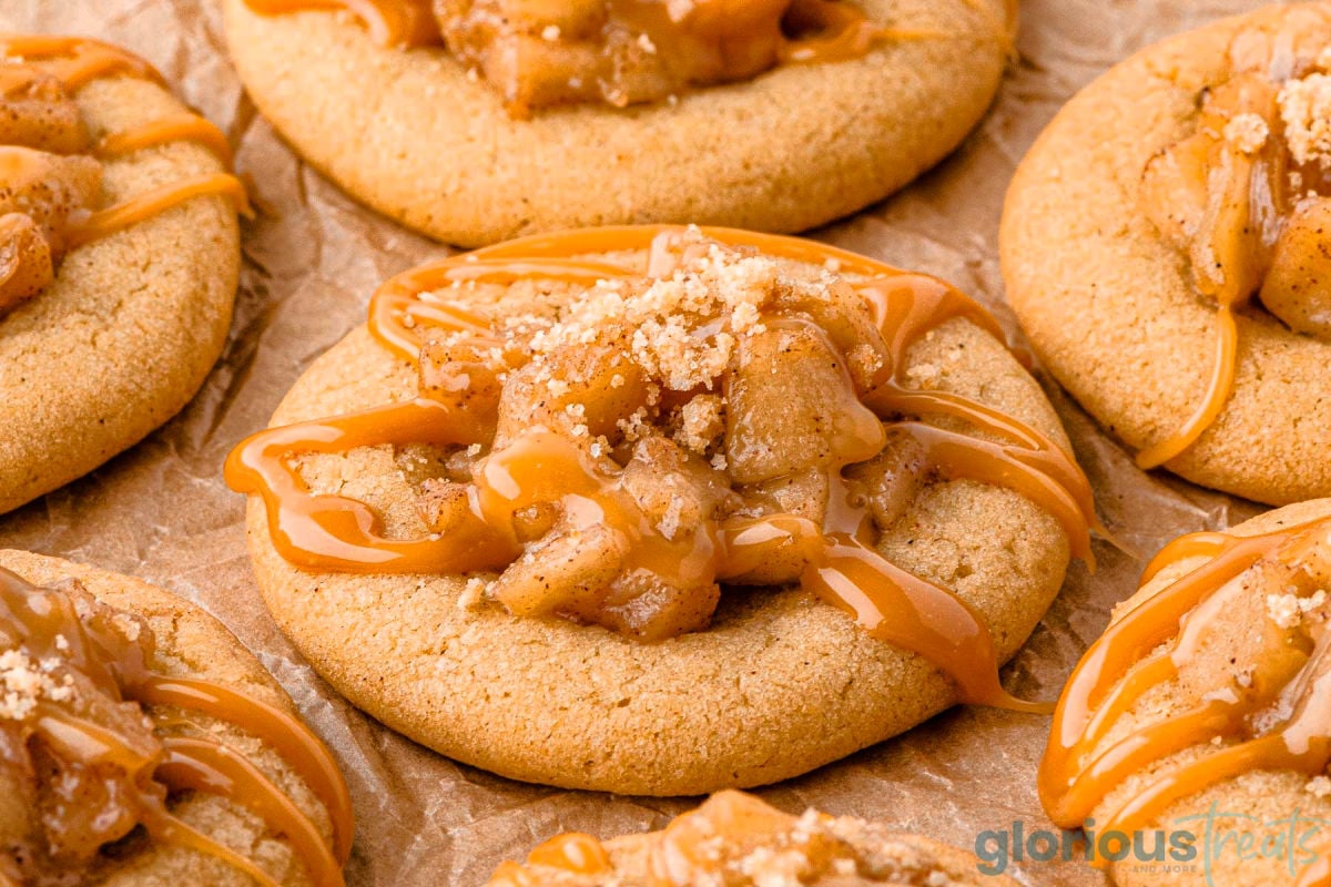 Wide shot of caramel apple cookies with apple filling, caramel sauce and streusel.