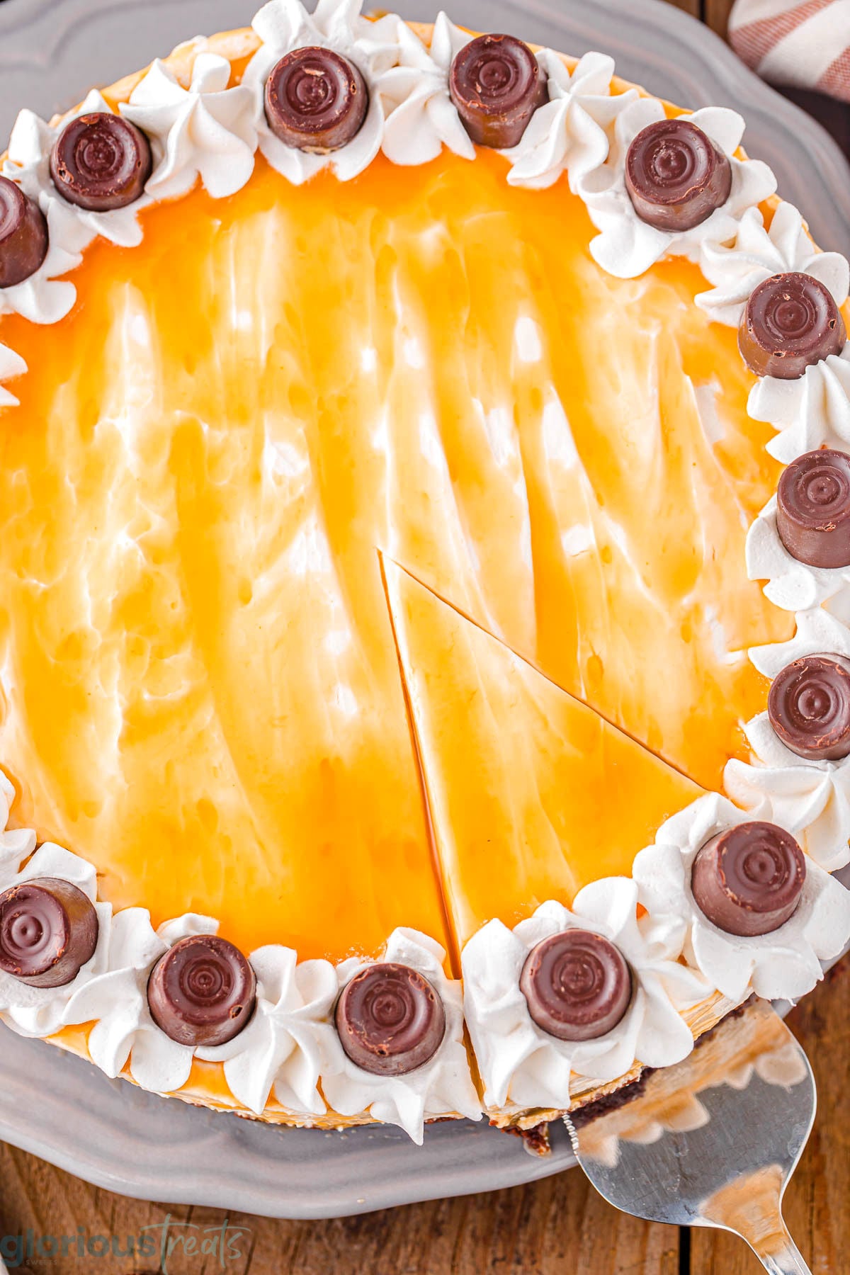 Close up overhead shot of caramel cheesecake with slice cut out of it.